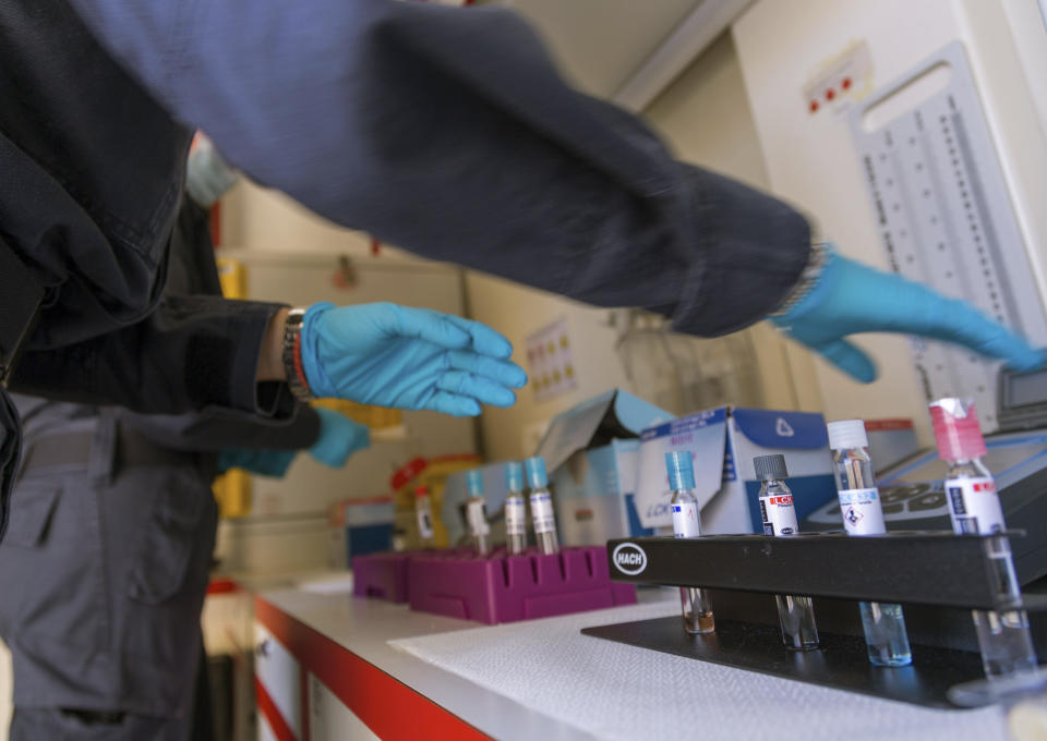 In this picture taken on Thursday, May 21, 2020, Italian Coast Guard's biologists show how they perform tests on sea water in a mobile lab during an interview with The Associated Press in Fiumicino, near Rome. Preliminary results from a survey of seawater quality during Italy’s coronavirus lockdown indicate a sharp reduction in pollution from human and livestock waste in the seas off Rome. Authorities stressed it was too soon to give the lockdown sole credit for the change. (AP Photo/Domenico Stinellis)