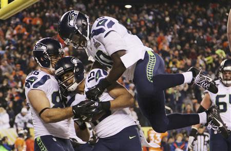 Seahawks wide receiver Kearse celebrates his touchdown against the Broncos with teammates Miller and Coleman during the NFL Super Bowl XLVIII football game in East Rutherford