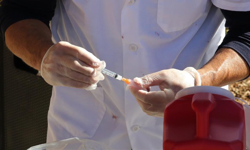 Pharmacist Patrick Lapanne of CVS Pharmacy prepares a dose of COVID-19 vaccine during a vaccine clinic in Las Cruces, N.M. on Monday, Dec. 28, 2020.