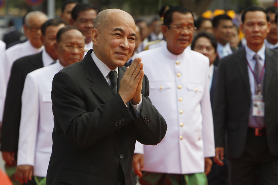 Cambodia's King Norodom Sihamoni, foreground, greets his government officers in front of the National Assembly in Phnom Penh, Cambodia, Wednesday, Sept. 5, 2018. Cambodian King Norodom Sihamoni on Wednesday presided over the opening of the first session of National Assembly to ensure long-ruling Prime Minister Hun Sen another term after his party swept election in late July. (AP Photo/Heng Sinith)