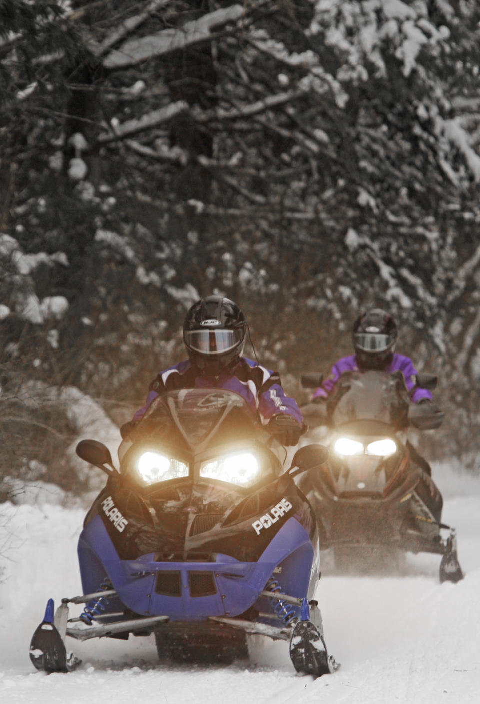 Snowmobiles travel a newly-groomed trail on Monday, Dec. 31, 2012 in East Montpelier, Vt. The big snow is giving a big boost to snowmobilers across Vermont, New Hampshire and Maine. Parts of the region have received two feet of snow and more over the last several days, giving a boost to the sport that was hampered last season by a near-snowless winter. (AP Photo/Toby Talbot)