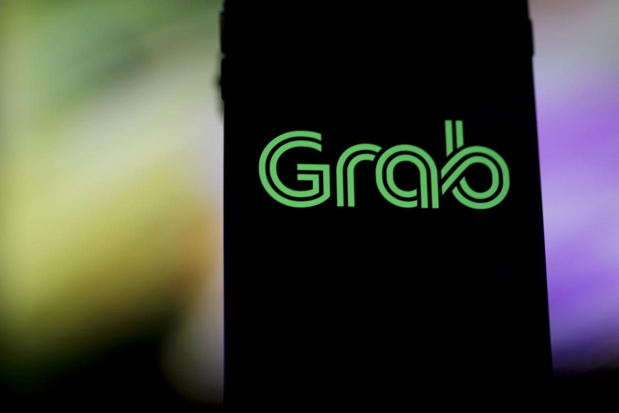 The Grab logo is displayed for a photograph on an Apple Inc. iPhone in Bangkok, Thailand, on Friday, March 9, 2018.  Photographer: Brent Lewin/Bloomberg