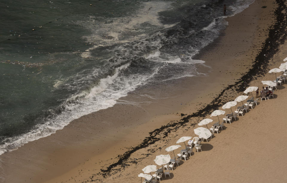 In this Aug. 8, 2019, photo, garbage creeps towards the shore at Stanley Beach in Alexandria, Egypt. Alexandria, which has survived invasions, fires and earthquakes since it was founded by Alexander the Great more than 2,000 years ago, now faces a new menace from climate change. Rising sea levels threaten to inundate poorer neighborhoods and archaeological sites, prompting authorities to erect concrete barriers out at sea to hold back the surging waves. (AP Photo/Maya Alleruzzo)