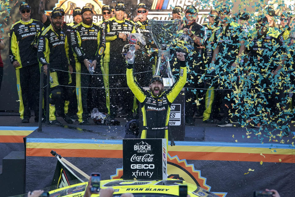 Ryan Blaney, foreground, celebrates after winning the NASCAR Cup Series Championship Cup at Phoenix Raceway, Sunday, Nov. 5, 2023, in Avondale, Ariz. (AP Photo/Darryl Webb)