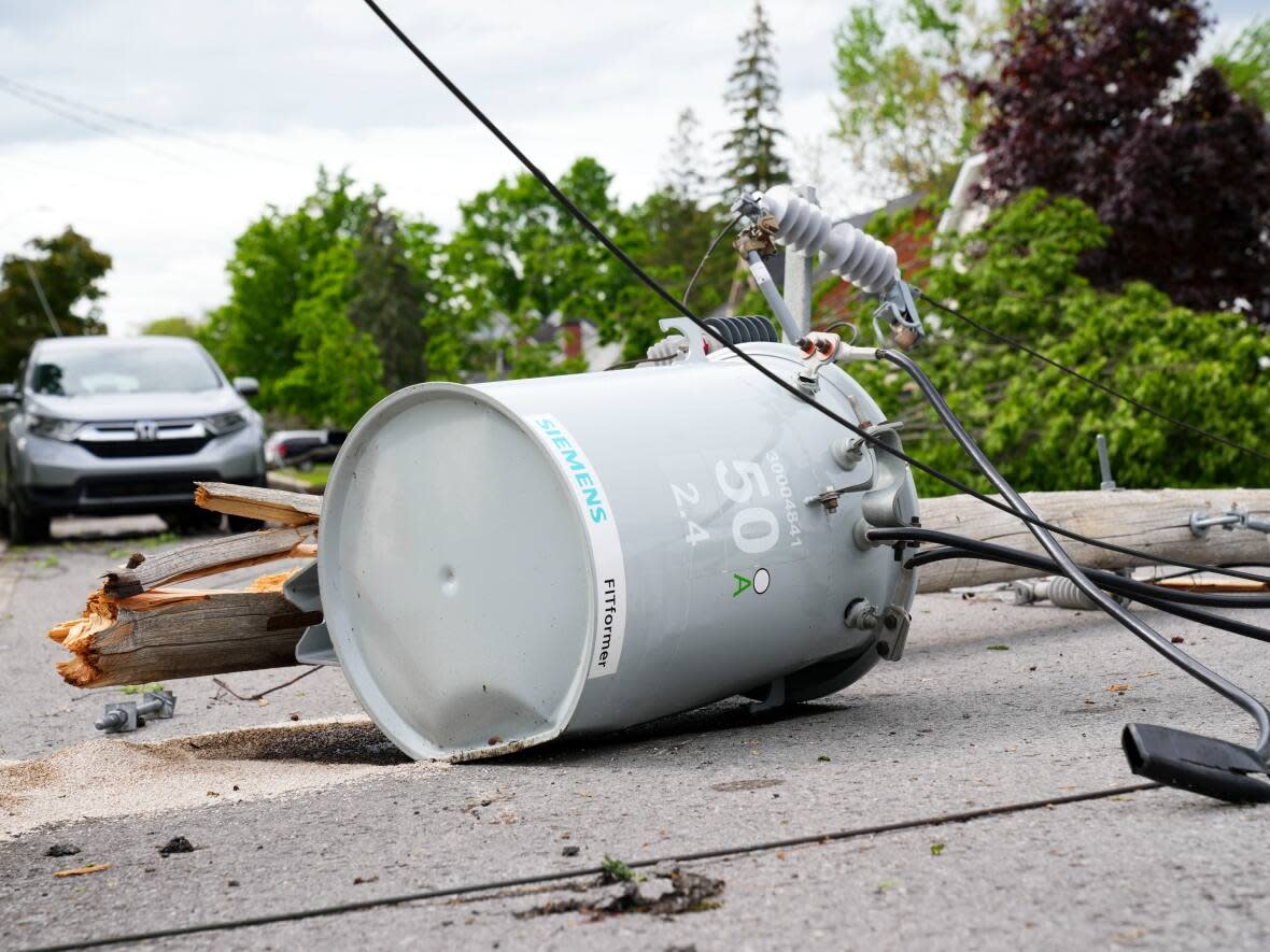 Hydro infrastructure and trees sit broken on a street in the Ottawa Valley municipality of Carleton Place, Ont., on Monday. A major storm hit the parts of Ontario and Quebec on Saturday, but some people say they didn't get the phone alert. (The Canadian Press - image credit)