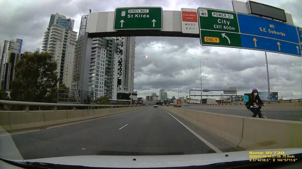 A delivery rider is pictured on Melbourne's M1 motorway.