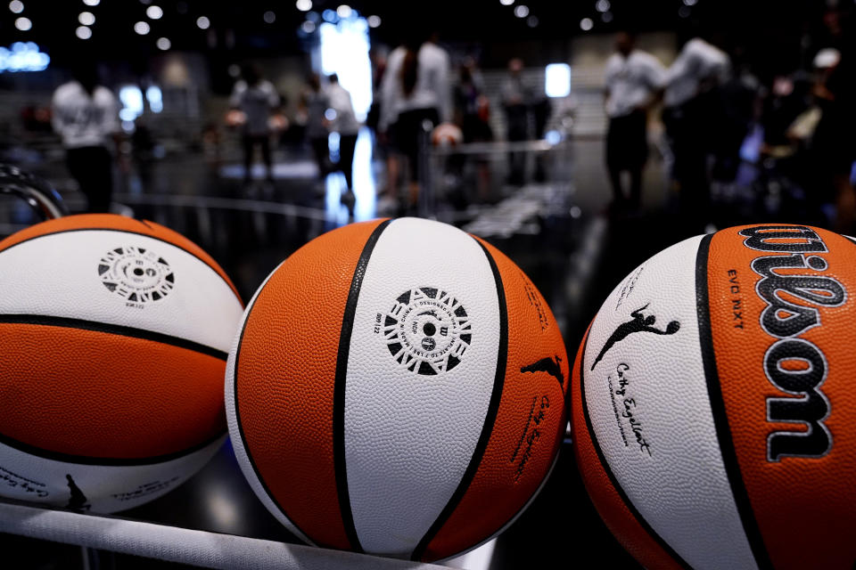 FILE - Basketballs sit in a rack during practice for the WNBA All-Star basketball game in Chicago, Saturday, July 9, 2022. Even the handful of players selected in the upcoming WNBA draft will find it difficult to continue their pro careers. There are only potentially 144 WNBA roster spots available and most of those are filled with returning players. (AP Photo/Nam Y. Huh, File)