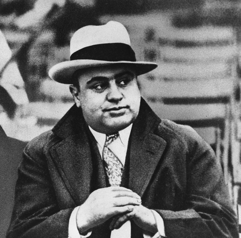 FILE - This Jan. 19, 1931 file photo shows Chicago mobster Al Capone at a football game. The legend of Eliot Ness, portrayed over the years by Kevin Costner and Robert Stack as an incorruptible hero, is now at risk, with some claiming his role in taking out Capone is as mythical as Mrs. O’Leary’s cow had to do with starting the Great Chicago Fire. Illinois’ two U.S. senators have proposed naming the Bureau of Alcohol, Tobacco, Firearms and Explosives in Washington after Ness, but Ed Burke, a prominent Chicago alderman and others are trying to convince the senators to drop the whole thing. (AP Photo/File)