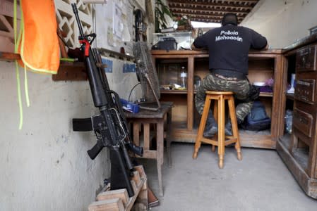 A vigilante is pictured the command headquarters in the municipality of Coahuayana