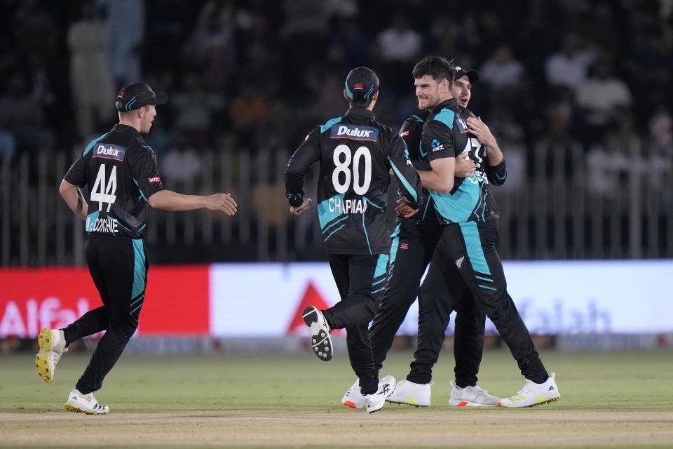 New Zealand's Ben Lester, right, celebrates with teammates after the dismissal of Pakistan's Saim Ayub during the second T20 international cricket match between Pakistan and New Zealand, in Rawalpindi, Pakistan, Saturday, April 20, 2024. (AP Photo/Anjum Naveed)