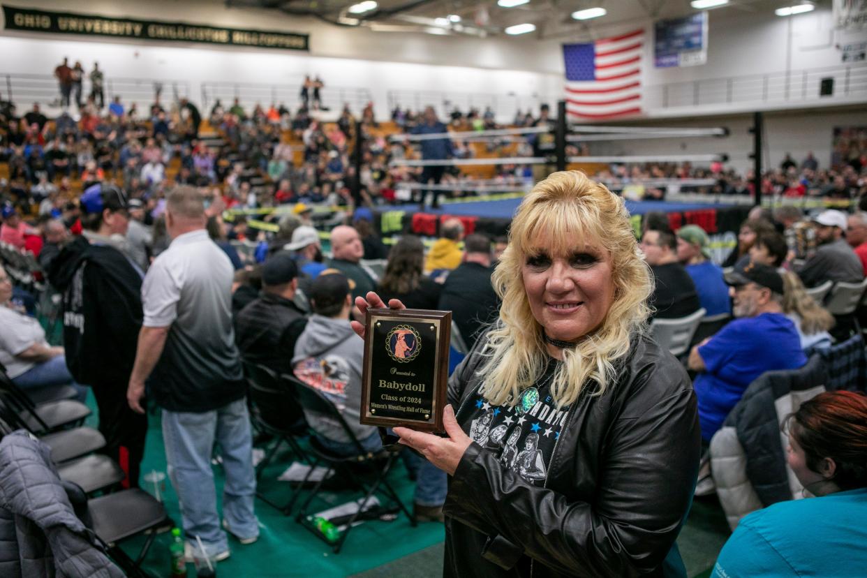 Baby Doll holds up her plaque she received after bring inducted into the Women's Wrestling Hall of Fame during the Big Time Wrestling event at Ohio University Chillicothe on Mar. 6. 2024, in Chillicothe, Ohio.