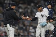 New York Yankees pitcher Marcus Stroman hands the ball to manager Aaron Boone as he leaves during the sixth inning of a baseball game against the Detroit Tigers, Friday, May 3, 2024, in New York. (AP Photo/Frank Franklin II)