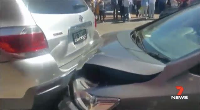 A five-year-old girl was pinned between two cars while waiting to cross the road between parked cars with her dad. Picture: 7 News