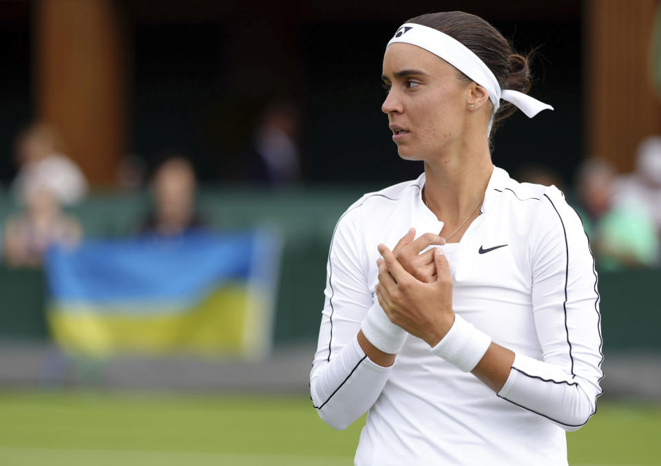 Ukraine's Anhelina Kalinina pauses as she plays against Hungary's Anna Bondar during a women's singles first round match on day one of the Wimbledon tennis championships in London, Monday, June 27, 2022. (John Walton/PA via AP)