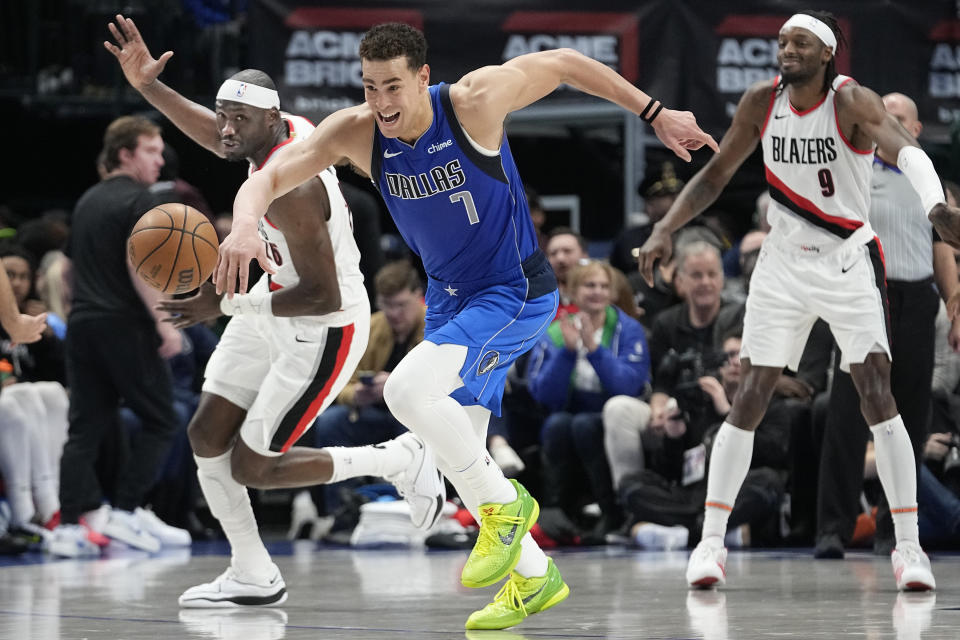 Dallas Mavericks center Dwight Powell (7) steals the ball from Portland Trail Blazers center Duop Reath, left, as Trail Blazers' Jerami Grant (9) looks on during the first half of an NBA basketball game in Dallas, Friday, Jan. 5, 2024. (AP Photo/LM Otero)