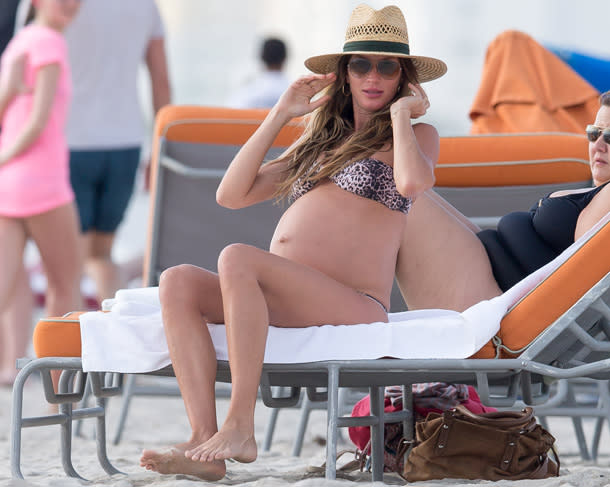 Gisele Bundchen shows off her pregnant belly in a bikini