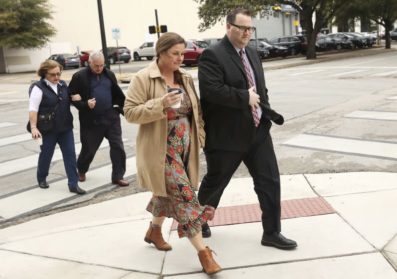 Eric Kay walks to the federal courthouse with family members.