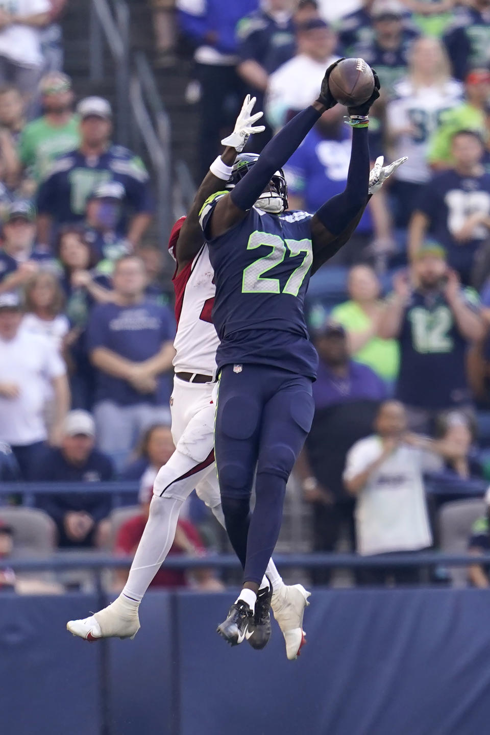 Seattle Seahawks cornerback Tariq Woolen (27) intercepts a pass intended for Arizona Cardinals wide receiver Marquise Brown, rear, during the second half of an NFL football game in Seattle, Sunday, Oct. 16, 2022. (AP Photo/Abbie Parr)