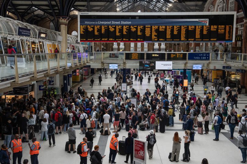 People wait for a train at Liverpool Street station