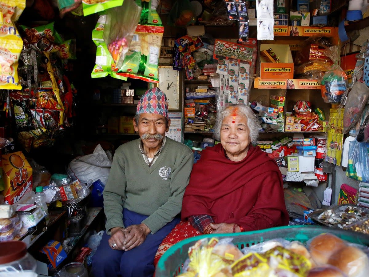 Nhuchhe Bahadur Amatya, 76, a retired accountant at Nepal Electricity Authority along with his wife Raywoti Devi Amatya, 74, a housewife, pose for a picture as they sit inside their shop in Lalitpur, Nepal, February 4, 2018. Nhuchhe was 17 and Raywoti was 15 when they had their arranged marriage 59 years ago. 