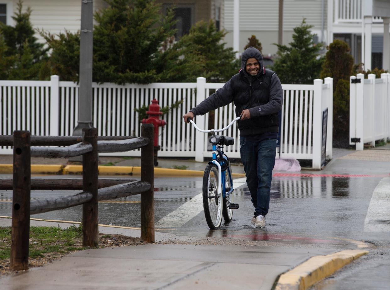 Frankie Olivo of Seaside Heights pushes his bike as a storm moves into the area. Rain falls throughout the Jersey Shore area with a risk of flooding for the region.   
Seaside Heights, NJ
Saturday, March 23, 2024