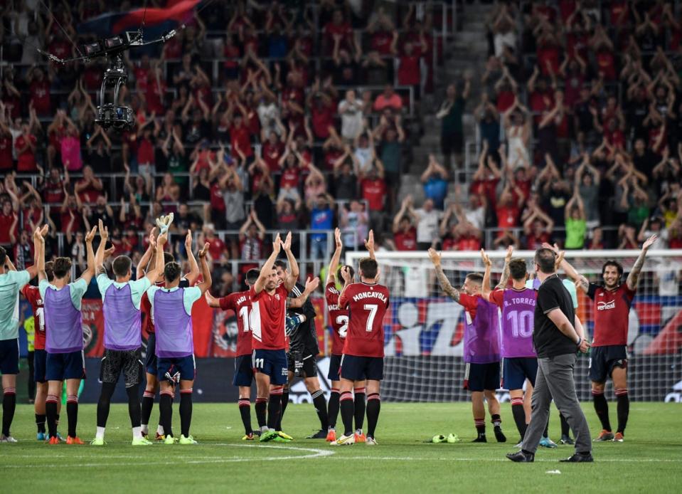 Osasuna’s players celebrate with their fans at El Sadar stadium in Pamplona (AFP via Getty Images)