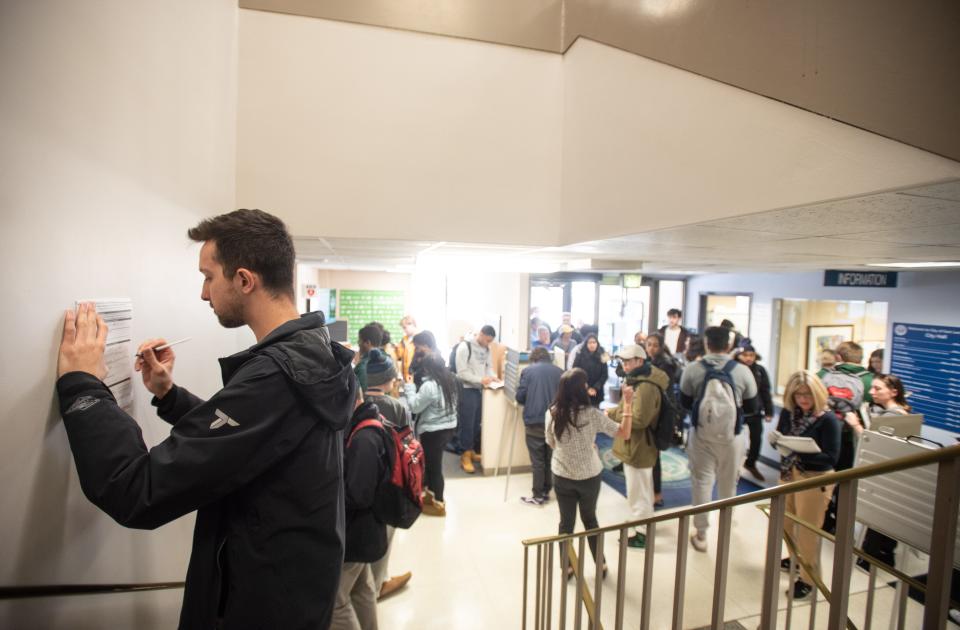 Michigan State junior Grant Dehner registers to vote at the East Lansing City Clerk's office Tuesday, March 10, 2020. He was one of several hundred in line registering to vote.