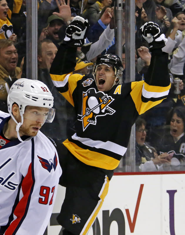 Pittsburgh Penguins' Evgeni Malkin, right, celebrates his second goal of the second period during an NHL hockey game against the Washington Capitals in Pittsburgh, Monday, Jan. 16, 2017. (AP Photo/Gene J. Puskar)