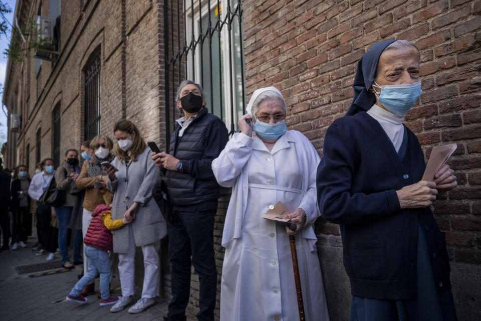 People queue to cast their votes during the regional election in Madrid, Spain, Tuesday, May 4, 2021. Over 5 million Madrid residents are voting for a new regional assembly in an election that tests the depths of resistance to lockdown measures and the divide between left and right-wing parties. (AP Photo/Bernat Armangue)