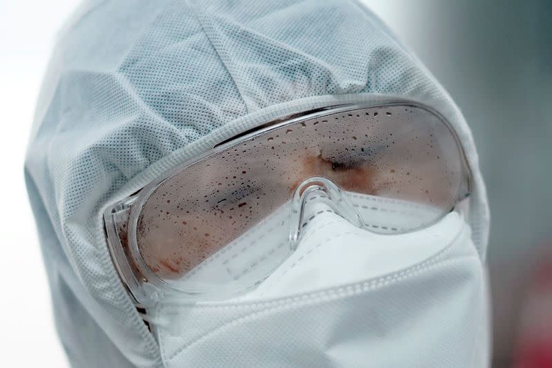 A volunteer from the Blue Sky Rescue team wearing a protective suit is seen at the Qintai Grand Theatre in Wuhan