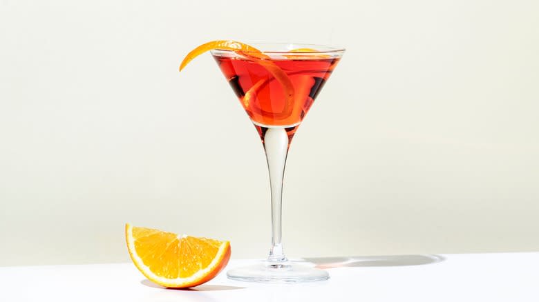 El Presidente cocktail beside orange slice