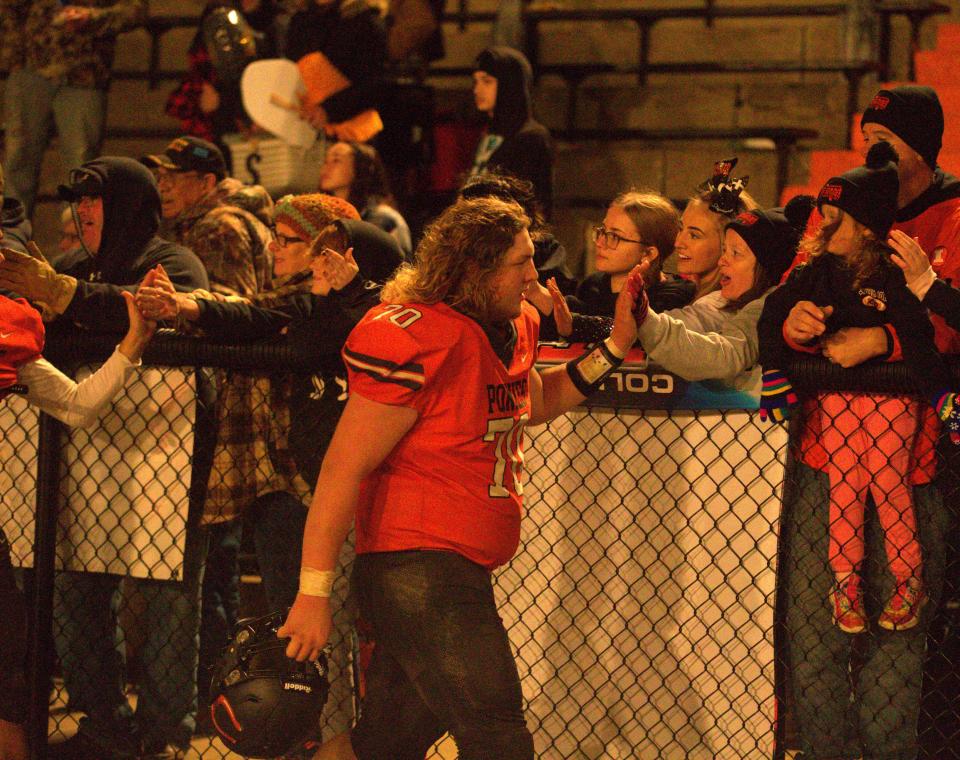 Kincaid South Fork's Connor Henley celebrates with fans following a 34-6 victory over Pawnee in an Illinois 8-Man Football Association game at Jack Hanlon Stadium on Saturday, Oct. 14, 2023.