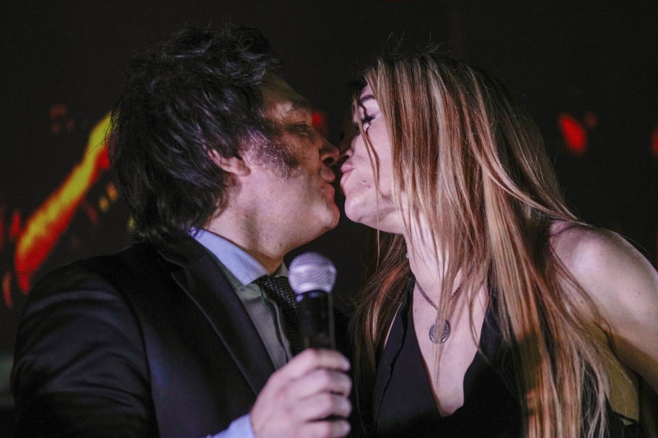 Presidential candidate of the Liberty Advances coalition Javier Milei, right, kisses his girlfriend Fatima Florez outside his campaign headquarters after winning the runoff election in Buenos Aires, Argentina, Sunday, Nov. 19, 2023. (AP Photo/Rodrigo Abd)