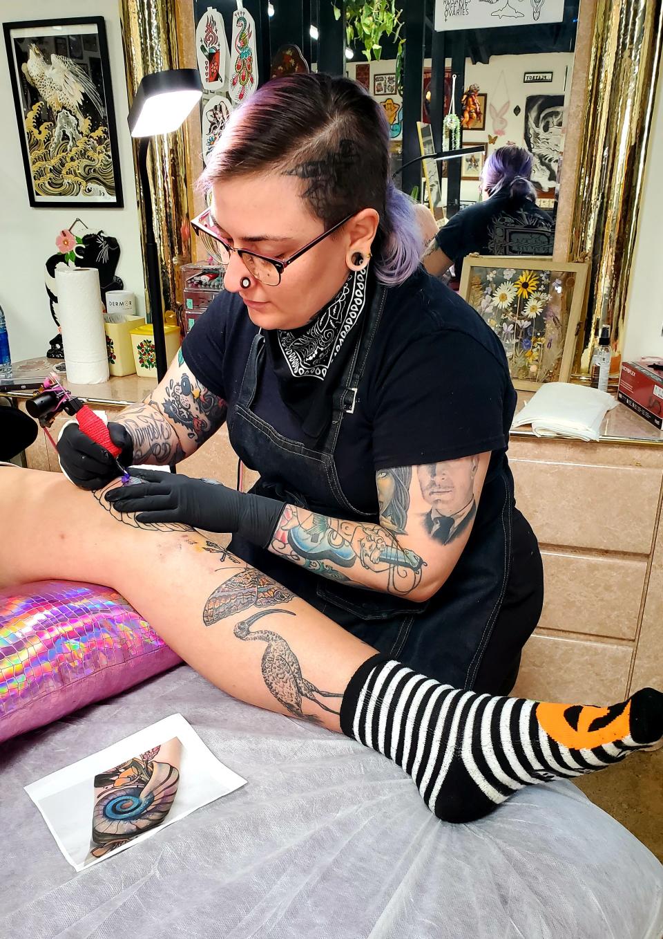 At Lady Magnolia Tattoo in Dallas, Texas, artist Andrea Patterson, 31, colors in an image of an ammonite for patron Kate Pelusio, 34, on Friday, July 1, 2022. Patterson planned to take part in the shop's pro-abortion flash sale later in the month to benefit abortion rights advocacy organizations.