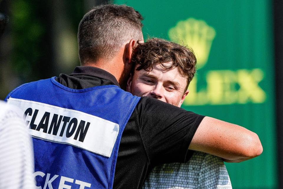 Luke Clanton hugs his caddie after finishing No. 18 during Round 3 of Rocket Mortgage Classic at Detroit Golf Club in Detroit on Saturday, June 29, 2024.