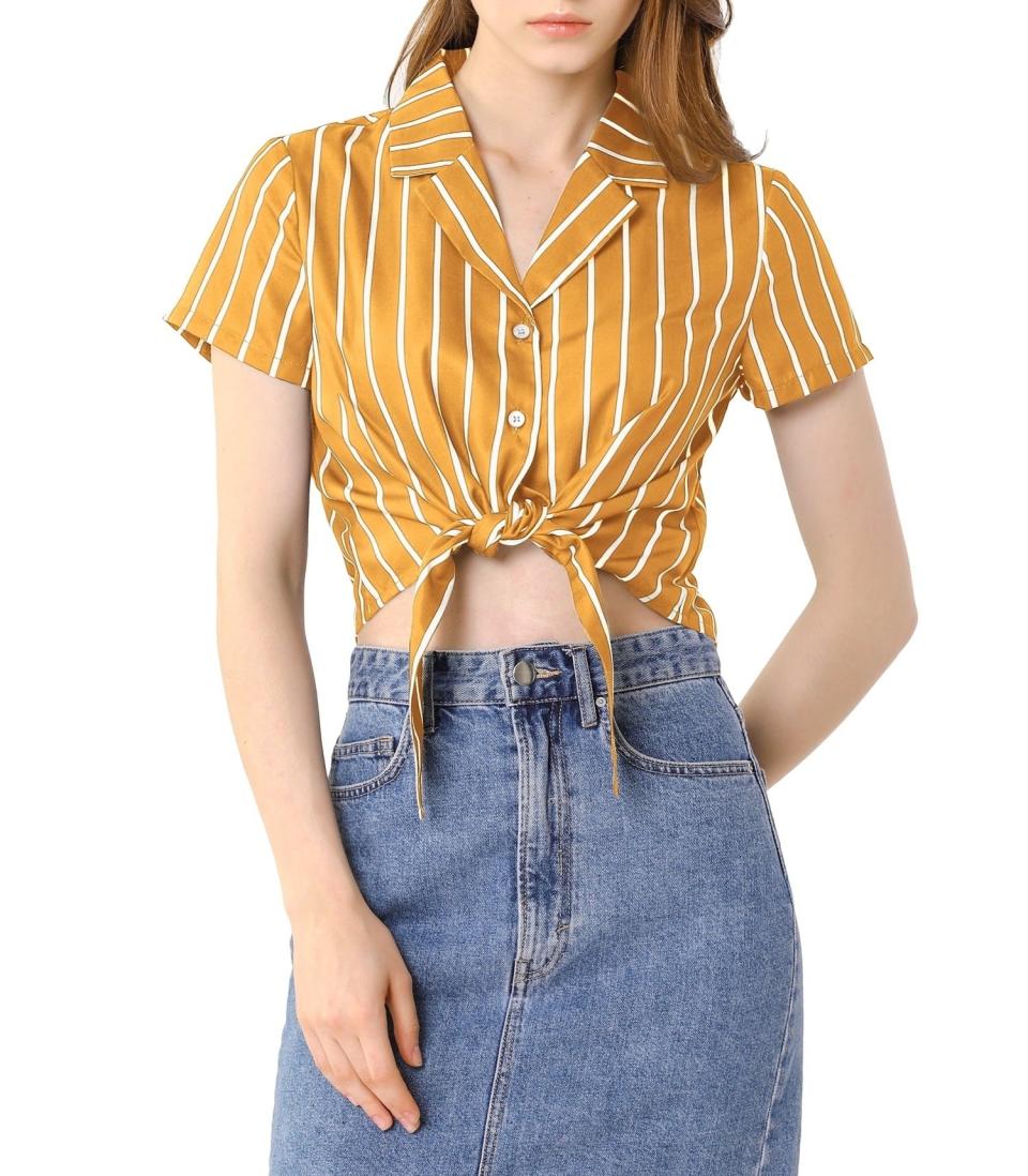 model in a striped tie-front yellow shirt with white stripes and a denim skirt