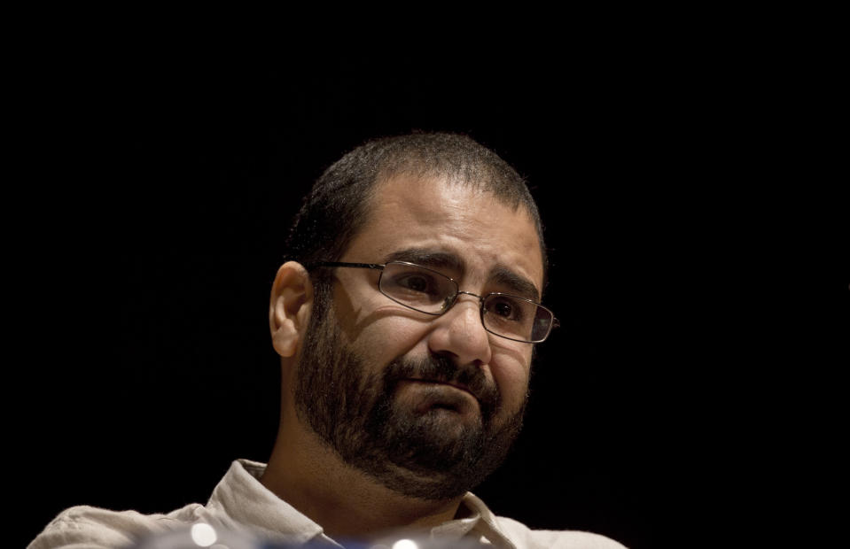 FILE - In this Monday, Sept. 22, 2014 file photo, Egypt's leading pro-democracy activist Alaa Abdel-Fattah takes a moment as he speaks about his late father Ahmed Seif, one of Egypt's most respected human rights lawyers, during a conference held at the American University in Cairo, Egypt. Abdel-Fattah was released from prison early Friday March 29, 2019, after serving a five-year sentence for inciting and taking part in protests, his family and lawyer said. (AP Photo/Nariman El-Mofty, File)