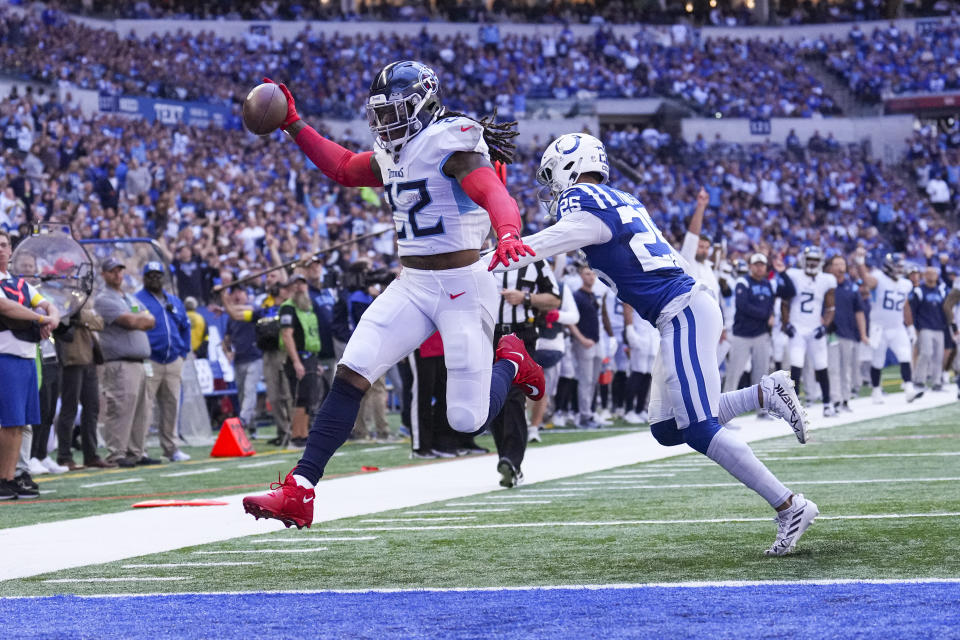 Tennessee Titans running back Derrick Henry leaps past Indianapolis Colts safety Rodney Thomas II for a touchdown in the first half of an NFL football game in Indianapolis, Fla., Sunday, Oct. 2, 2022. (AP Photo/AJ Mast)