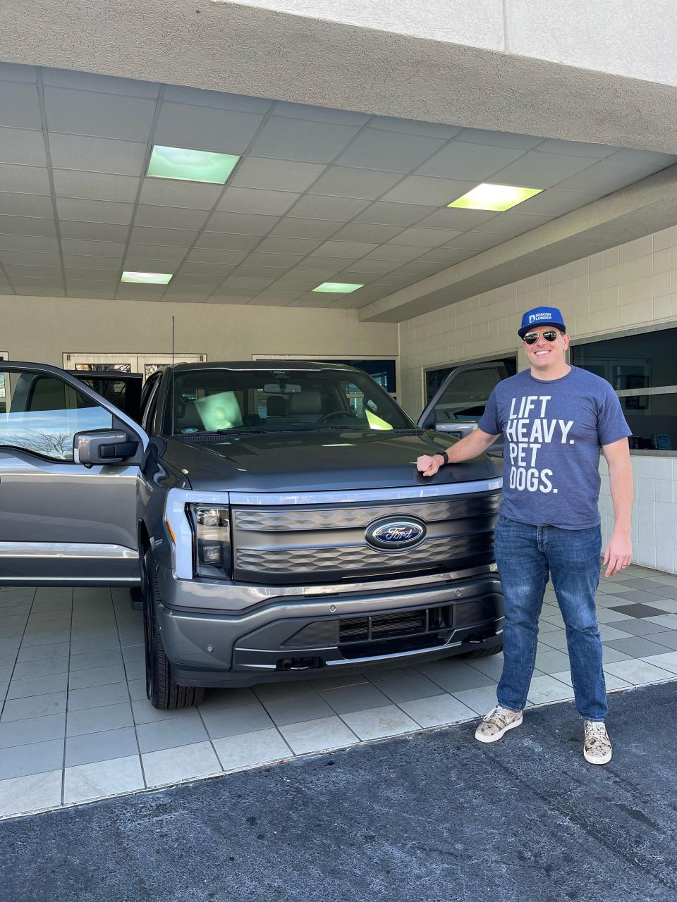 author george pearkes standing with his new ford f-150 lightning