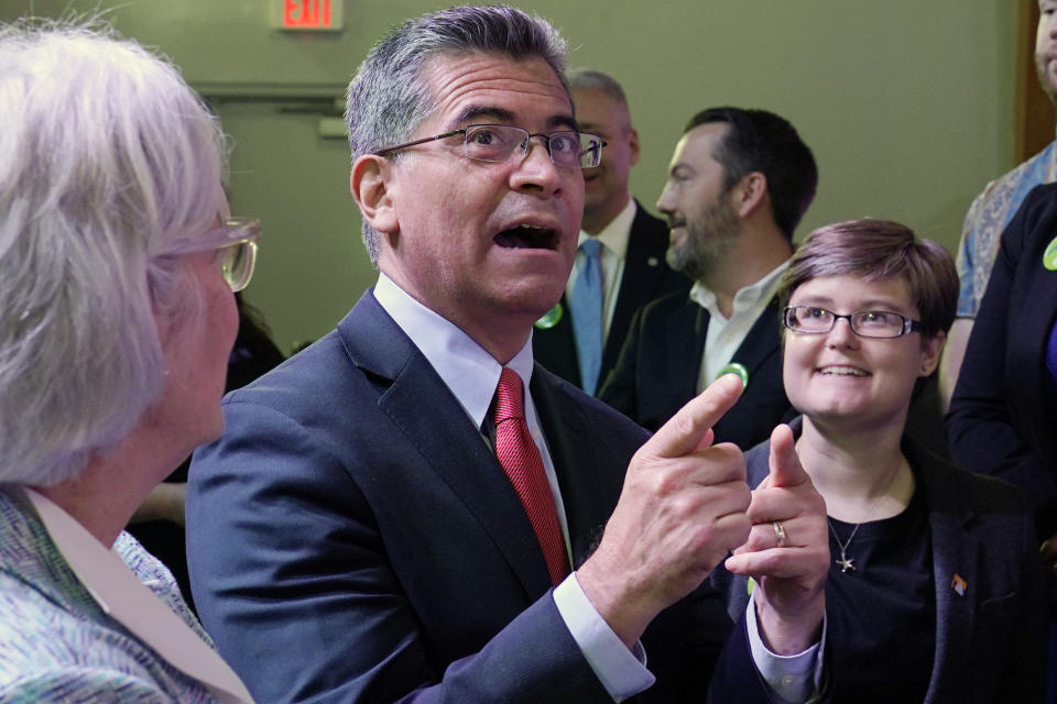 U.S. Department of Health and Human Services (HHS) Secretary Xavier Becerra, center, talks with with Oklahoma Medicaid advocates following a news conference Thursday, July 1, 2021, in Tulsa, Okla., as Oklahoma expands its Medicaid program. (AP Photo/Sue Ogrocki)