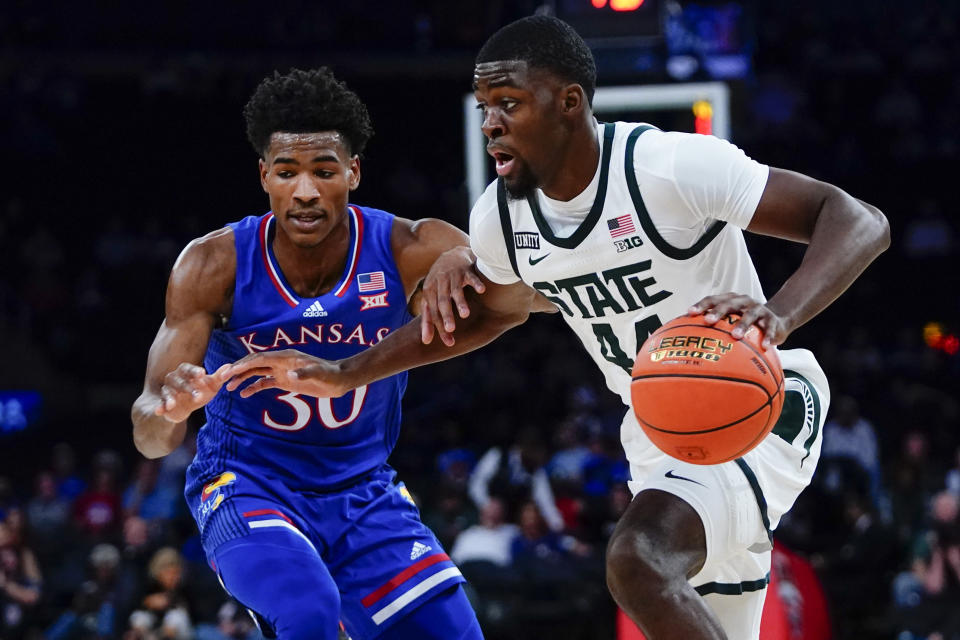 Michigan State's Gabe Brown (44) drives past Kansas' Ochai Agbaji (30) during the first half of an NCAA basketball game Tuesday, Nov. 9, 2021, in New York. (AP Photo/Frank Franklin II)