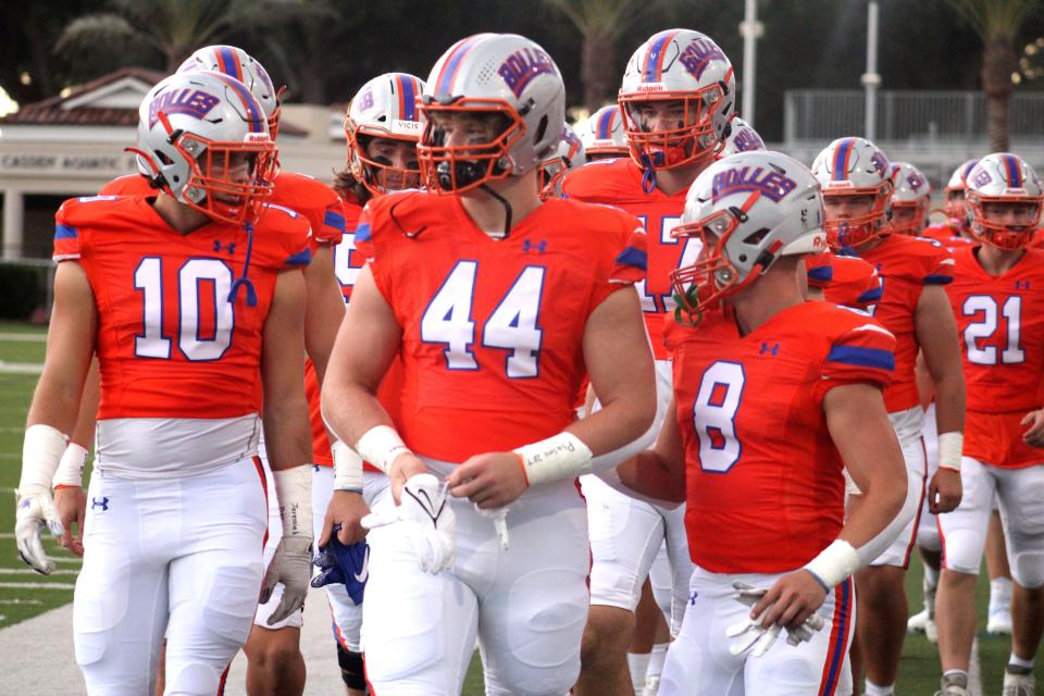 Bolles linebackers Deklan Dougherty (10) and Jack Pyburn (44) and running back Kade Frew (8) lead their team onto the field before a high school football game  against St. Augustine on September 10, 2021. [Clayton Freeman/Florida Times-Union]