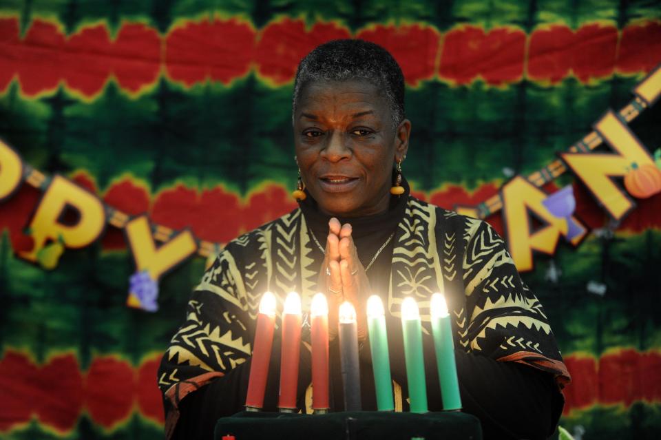 Seven candles are lit on a kinara to celebrate Kwanzaa.