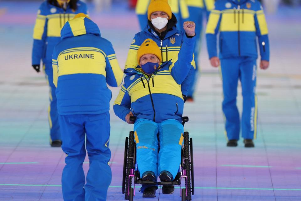 Members of Team Ukraine wave during the Opening Ceremony of the Beijing 2022 Winter Paralympics