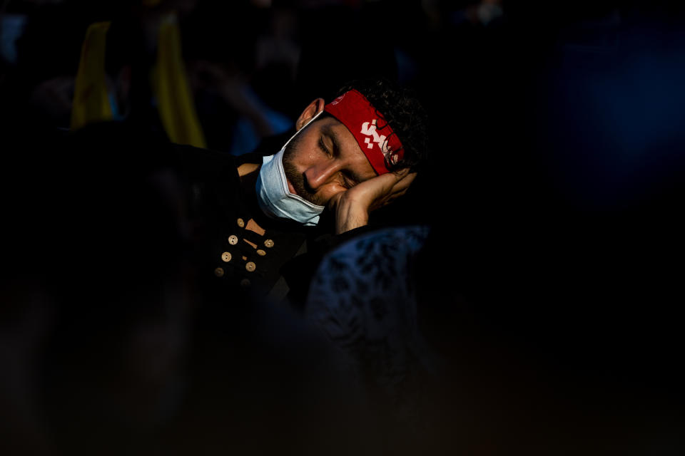 A Lebanese Shiite supporter of Hezbollah listens to the story of Imam Hussein, during activities marking the holy day of Ashoura, in southern Beirut, Lebanon, Thursday, Aug. 19, 2021. The leader of the militant Hezbollah group Sayyed Hassan Nasrallah said Thursday that the first Iranian fuel tanker will sail toward Lebanon "within hours" warning Israel and the United States not to intercept it. The Arabic head band reads:"Hussein." (AP Photo/ Hassan Ammar)