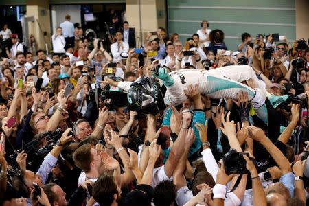 Formula One - F1 - Abu Dhabi Grand Prix - Yas Marina Circuit, Abu Dhabi, United Arab Emirates - 27/11/2016 - Mercedes' Formula One driver Nico Rosberg of Germany is carried by fans after winning Formula One world championship. REUTERS/Ahmed Jadallah