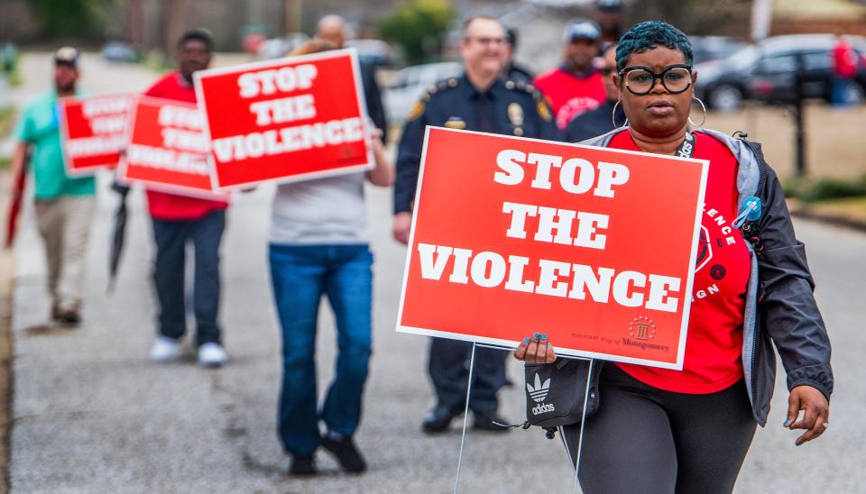 Community volunteers and leaders, including Ro Tyus Hollyfield, with the Montgomery city Office of Violence Prevention, take part in a Stop the Violence Walk in the North Pass Community in north Montgomery, Ala., on Saturday February 10, 2024.