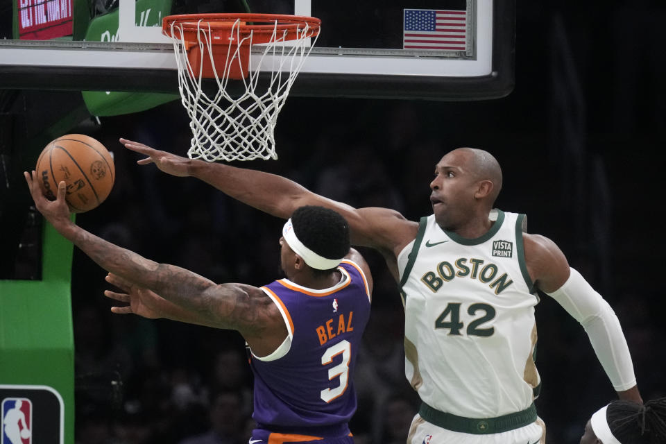 Boston Celtics center Al Horford (42) tries to block a shot by Phoenix Suns guard Bradley Beal (3) during the first half of an NBA basketball game, Thursday, March 14, 2024, in Boston. (AP Photo/Charles Krupa)
