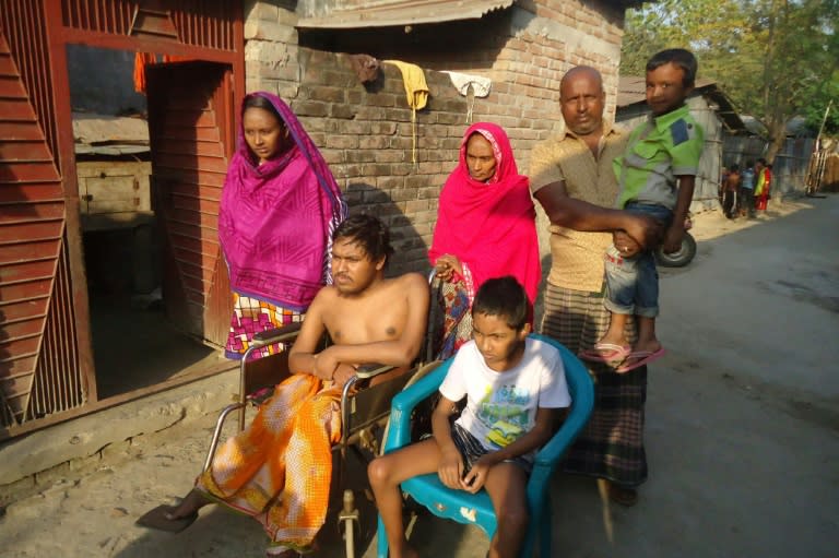 Bangladeshi father and fruit vendor Tofazzal Hossain (standing), who has sparked a debate over assisted suicide, seen with his family in Meherpur