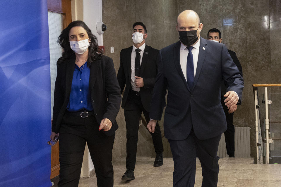 Israeli Prime Minister Naftali Bennett, right, and Israeli Interior Minister Ayelet Shaked, left, arrive for the weekly cabinet meeting in Jerusalem, Sunday, Dec. 12, 2021. Bennett announced that he would make the first official visit by a sitting premier to the United Arab Emirates on Sunday as part of a blitz of regional diplomacy amid the backdrop of struggling nuclear talks with Iran. (AP Photo/Tsafrir Abayov, Pool)